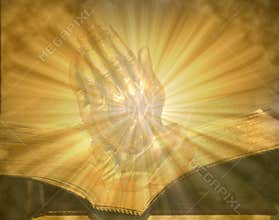 Praying Hands on Open Lighted Bible