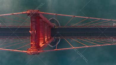 Cinematic top view of San Francisco in misty golden sunset light, cars driving