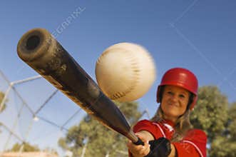 Female Baseball Player Hitting A Shot