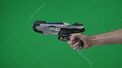 In a shot on a green background, a chromakey male hand that holds, holds out a plastic gun, a blaster, he pulls the