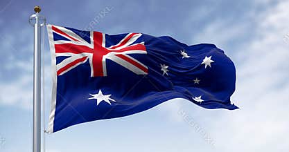 Three Australia national flags waving in the wind on a clear day