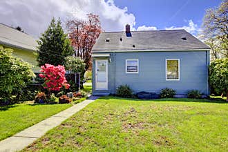 Blue small house with spring landscape from backyard.
