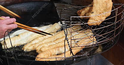 Cooking Chinese deep-fried dough stick also called youtiao