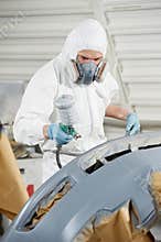 Auto mechanic painting car bumper