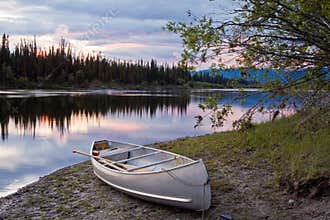 Sunset sky and canoe at Teslin River Yukon Canada