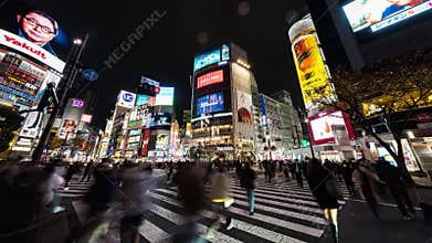Time lapse of car traffic transportation, people walk cross road at Shibuya scramble crossing. Tokyo Japan travel transport