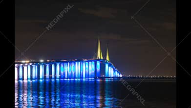 Time-lapse video of the lighted Sunshine Skyway Bridge at night during a cruise ship transit