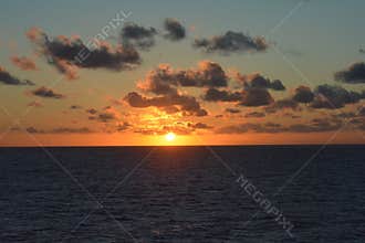 Golden Ocean Sunset with Dramatic Clouds on the Horizon