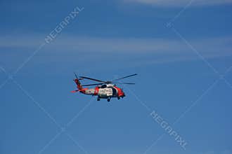 United States Coast Guard Helicopter in Flight Against Clear Blue Sky