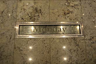 Engraved \'Monday\' Plaque on Marble Wall