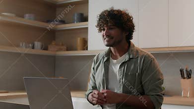 Happy smiling Indian man has online meeting video call speak virtual chat with family friends talking casual