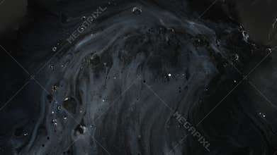 Liquid black colors flowing in macro