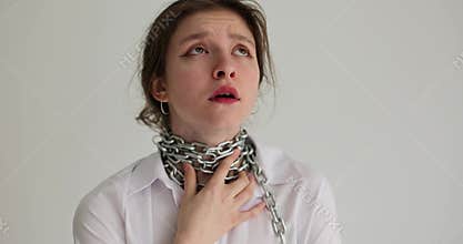 Portrait of woman touches chain around neck