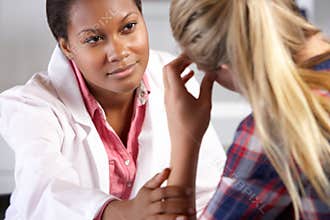Teenage Girl Visits Doctor's Office Suffering With Depression