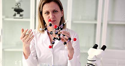 Doctor demonstrates molecule model explaining research