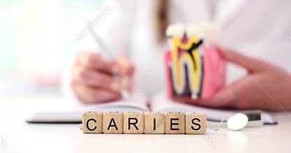 Dentist fills in patient medical history and word caries