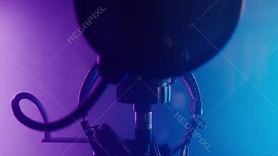 professional microphone and headphones for music and sound recording in isolation booth of studio