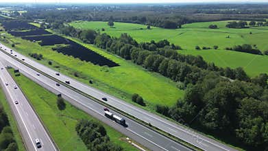 Aerial view on the A7 motorway in northern Germany between fields and meadows