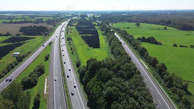Aerial view on the A7 motorway in northern Germany between fields and meadows