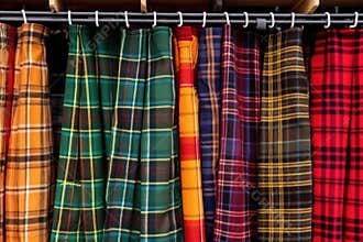 scottish tartan kilts hanging side by side in close detail