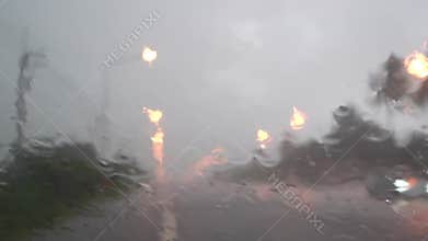 Rainny mood , Raindrops bokeh on the car traffic rearview mirror. Heavy rain outside.