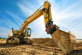 Big excavator in front of the blue sky