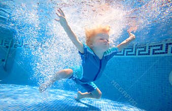 Young boy swimming underwater