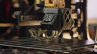A 3d printer machine is making volume geometric figure. The working process printing illustration. A modern automatic