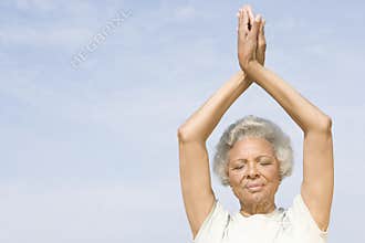Senior Woman With Eyes Closed In Yoga Pose