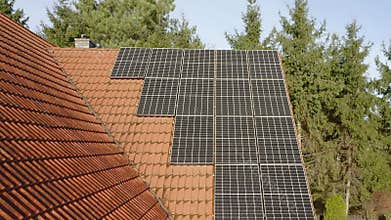 Monocrystalline photovoltaic cells made of solid silicon crystal on a tiled roof