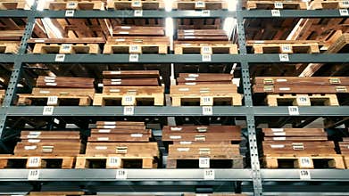 storage of goods on wooden shelves of a large warehouse. Storage of cardboard boxes on wooden pallets