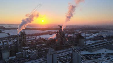 Aerial view of cement factory with high concrete plant structure and tower crane at industrial production area in