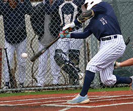 Baseball batter hitting a ball during a game