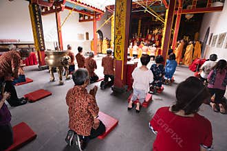 Bandung, Indonesia - January 8, 2022 : the congregation praying together at the Buddhist altar with the monks