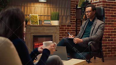 Male therapist listening to man and woman complaining