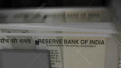 500 Indian rupees in cash dispenser. Withdrawal of cash from an ATM. INR.