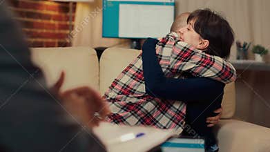 Cheerful couple hugging after making peace at counseling session