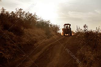 Farmer rides on the tractor