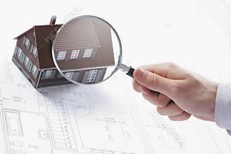 Magnifying glass and house.