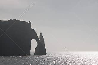 Stone Arch in Normandy coast in haze