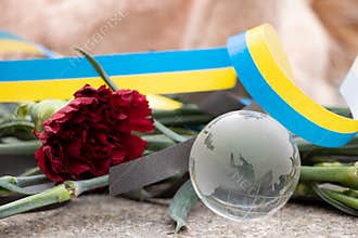 Toys and flowers lie at a trolleybus stop next to a house blown up by a Russian rocket on Pobeda in the city of Dnepr in Ukraine