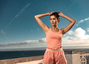 Fitness girl rest after practicing yoga or running outdoors. Fitness concept. Download a photo to advertise a fitness