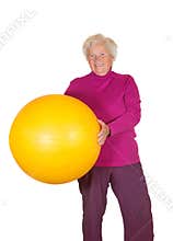 Happy retired woman holding gym ball