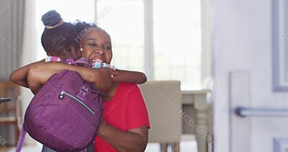 Video of african american granddaughter with schoolbag coming home and hugging happy grandmother