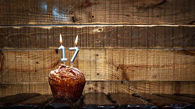 Background happy birthday pie or muffin with candles burning digit number 17. Festive card Happy Birthday on the background of