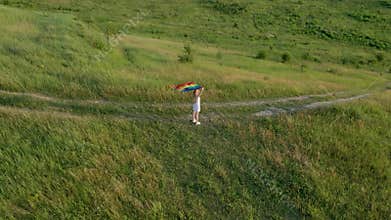 Woman lesbian with LGBT flag on a green montains