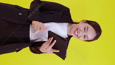 Portrait young asian businesswoman in suit standing using tablet computer to internet isolated.