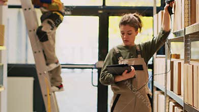 Depot worker scanning packages on racks