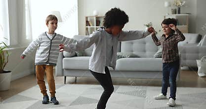 Talented African dancer boy teaching diverse friends to dance