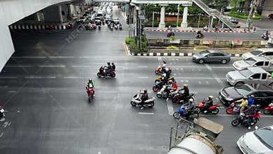 Morning traffic in Bangkok with motorbikes driving through traffic